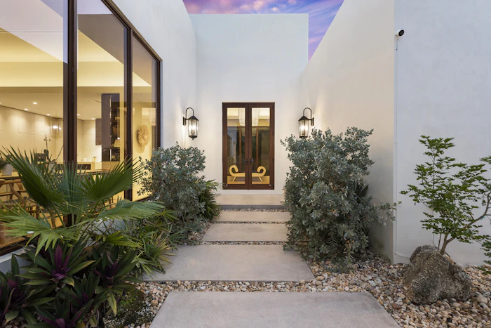 View of villa entrance and floor to cieling windows in Miami
